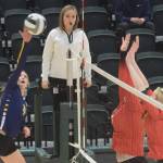 Homer's Gracie Gummer goes up for a kill against Kenai blockers Calani Holmes and Emma Beck during the 3A state volleyball consolation game at the Alaska Airlines Center in Anchorage, Alaska, on Saturday, Nov. 13, 2021. (Camille Botello/Peninsula Clarion)
