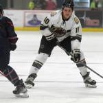 Kenai River Brown Bears forward Caden Triggs carries the puck against Anchorage Wolverines defenseman Campbell Cichosz on Friday, Nov. 5, 2021, at the Soldotna Regional Sports Complex in Soldotna, Alaska. (Photo by Jeff Helminiak/Peninsula Clarion)