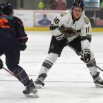 Kenai River Brown Bears forward Caden Triggs carries the puck against Anchorage Wolverines defenseman Campbell Cichosz on Friday, Nov. 5, 2021, at the Soldotna Regional Sports Complex in Soldotna, Alaska. (Photo by Jeff Helminiak/Peninsula Clarion)