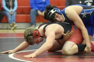 Soldotna's Isaac Chavarria wrestles to a major decision over Kenai Central's Andrew Gaethle at 152 pounds during a dual meet at Kenai Central High School on Tuesday, Nov. 16, 2021, in Kenai, Alaska. (Photo by Jeff Helminiak/Peninsula Clarion)