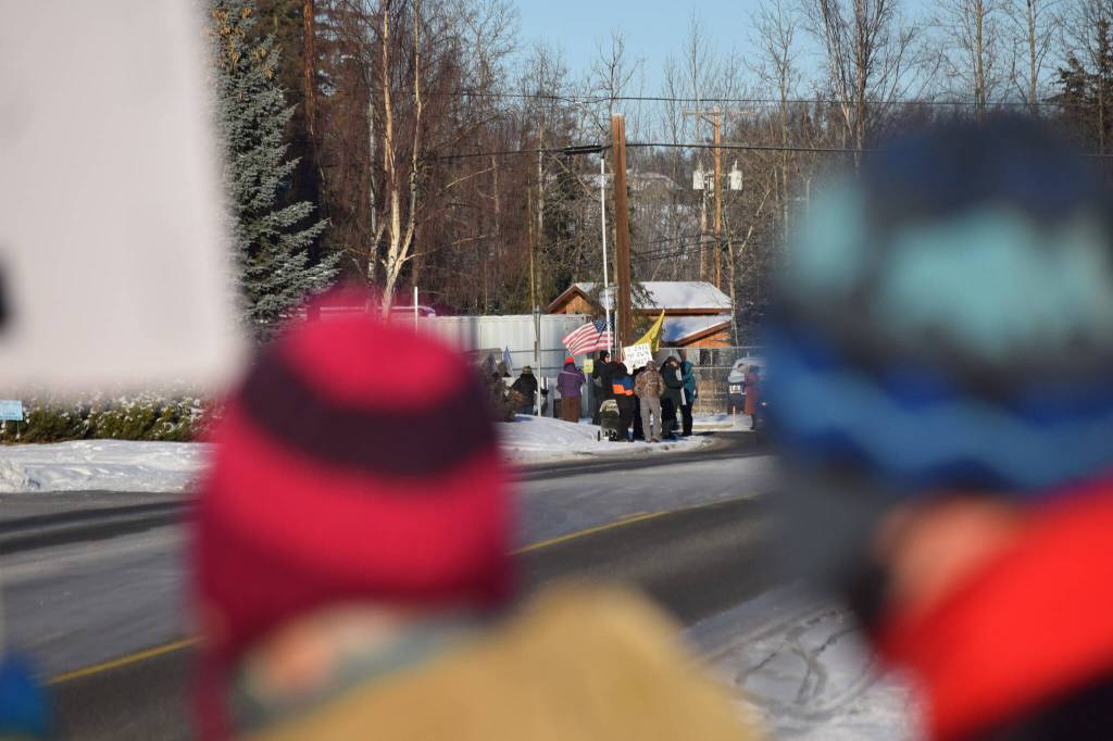 Members of the Many Voices advocacy group gather outside of Central Peninsula Hospital in Soldotna to demonstrate their support for healthcare staff on Saturday, Nov. 20, 2021. Folks protesting COVID-19 vaccine mandates and advocating for alternative treatments stand down the block behind them. (Camille Botello/Peninsula Clarion)