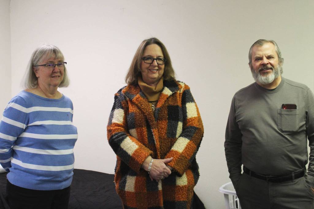 Kathy Gensel (left), Leslie Rohr (center) and Tim Navarre (right) stand in a bedroom at a cold weather shelter set to open next month on Monday, Nov. 22, 2021 in Nikiski, Alaska. (Ashlyn O'Hara/Peninsula Clarion)