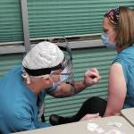 Family practice physician Christina Tuomi, D.O., (right) gets Homers first dose of Pfizers COVID-19 vaccine from Emergency Department nurse Steve Hughes (left) on Thursday, Dec. 17, 2020 at South Peninsula Hospital in Homer, Alaska. Tuomi has been the hospitals medical lead throughout the pandemic. (Photo courtesy Derotha Ferraro/South Peninsula Hospital)