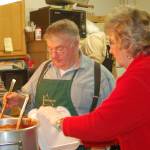 Homer News Ben Mitchell, left, serves spaghetti to helper Pat Wells in the kitchen at a past Share the Spirit spaghetti feed. (Michael Armstrong/Homer News file)