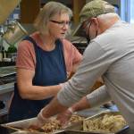 Cheryl Morse and Tom Kleeman prepare Thanksgiving lunch at the Kenai Peninsula Food Bank on Wednesday, Nov. 24, 2021. (Camille Botello/Peninsula Clarion)