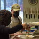 Anne and Tom Kleeman prepare Thanksgiving lunch at the Kenai Peninsula Food Bank on Wednesday, Nov. 24, 2021. (Camille Botello/Peninsula Clarion)