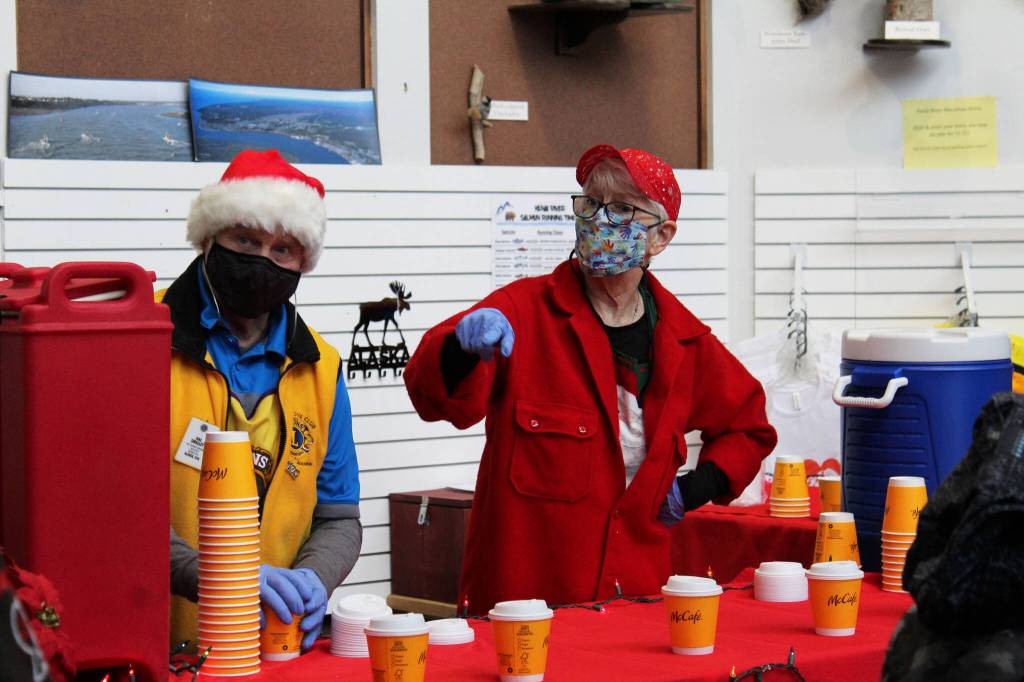 Hal (left) and Susan Smalley serve hot chocolate at the Kenai Chamber of Commerce and Visitor Center as part of the Christmas Comes to Kenai event on Friday, Nov. 26, 2021 in Kenai, Alaska. (Ashlyn OHara/Peninsula Clarion)