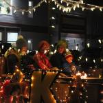 People sit on a float by Kendall Auto Group during the Christmas Comes to Kenai parade on Friday, Nov. 26, 2021 in Kenai, Alaska. (Ashlyn OHara/Peninsula Clarion)
