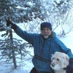 Michael Armstrong and his dog Leia harvest a Christmas tree in December 2013 on his land on Diamond Ridge near Homer, Alaska. (Photo by Jenny Stroyeck)