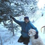 Michael Armstrong and his dog Leia harvest a Christmas tree in December 2013 on his land on Diamond Ridge near Homer, Alaska. (Photo by Jenny Stroyeck)