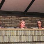 Kenai City Council members James Baisden (left) and Deborah Sounart (right) listen as member Teea Winger (center) speaks in support of legislation opposing government COVID-19 mandates, during a meeting of the Kenai City Council on Wednesday, in Kenai.