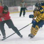 Brandonn Campbell of Juneau-Douglas keeps the puck from Dylan Arno of Homer on Friday, Dec. 3, 2021, at Kevin Bell Arena in Homer, Alaska. (Photo by Sarah Knapp/Homer News)