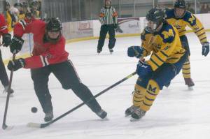 Brandonn Campbell of Juneau-Douglas keeps the puck from Dylan Arno of Homer on Friday, Dec. 3, 2021, at Kevin Bell Arena in Homer, Alaska. (Photo by Sarah Knapp/Homer News)