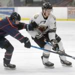 Carter Green of the Kenai River Brown Bears tries to get around Danny Reis of the Anchorage Wolverines on Friday, Dec. 3, 2021, at the Soldotna Regional Sports Complex in Soldotna, Alaska. (Photo by Jeff Helminiak/Peninsula Clarion)