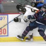 Nick Stevens of the Kenai River Brown Bears tries to squeeze by the check of Bohdan Panasenko of the Anchorage Wolverines on Friday, Dec. 3, 2021, at the Soldotna Regional Sports Complex in Soldotna, Alaska. (Photo by Jeff Helminiak/Peninsula Clarion)