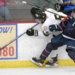 Nick Stevens of the Kenai River Brown Bears tries to squeeze by the check of Bohdan Panasenko of the Anchorage Wolverines on Friday, Dec. 3, 2021, at the Soldotna Regional Sports Complex in Soldotna, Alaska. (Photo by Jeff Helminiak/Peninsula Clarion)