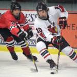 Kenai Centrals Reagan Graves gets ready to score a goal while Camden Kovach defends Saturday, Dec. 4, 2021, at the Kenai Multi-Purpose Facility in Kenai, Alaska. (Photo by Jeff Helminiak/Peninsula Clarion)