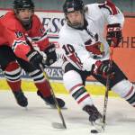 Kenai Central's Reagan Graves gets ready to score a goal while Camden Kovach defends Saturday, Dec. 4, 2021, at the Kenai Multi-Purpose Facility in Kenai, Alaska. (Photo by Jeff Helminiak/Peninsula Clarion)