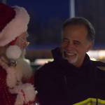 State Sen. Peter Micciche takes photos with Santa at Soldotna Creek Park on Saturday, Dec. 4, 2021. (Camille Botello/Peninsula Clarion)
