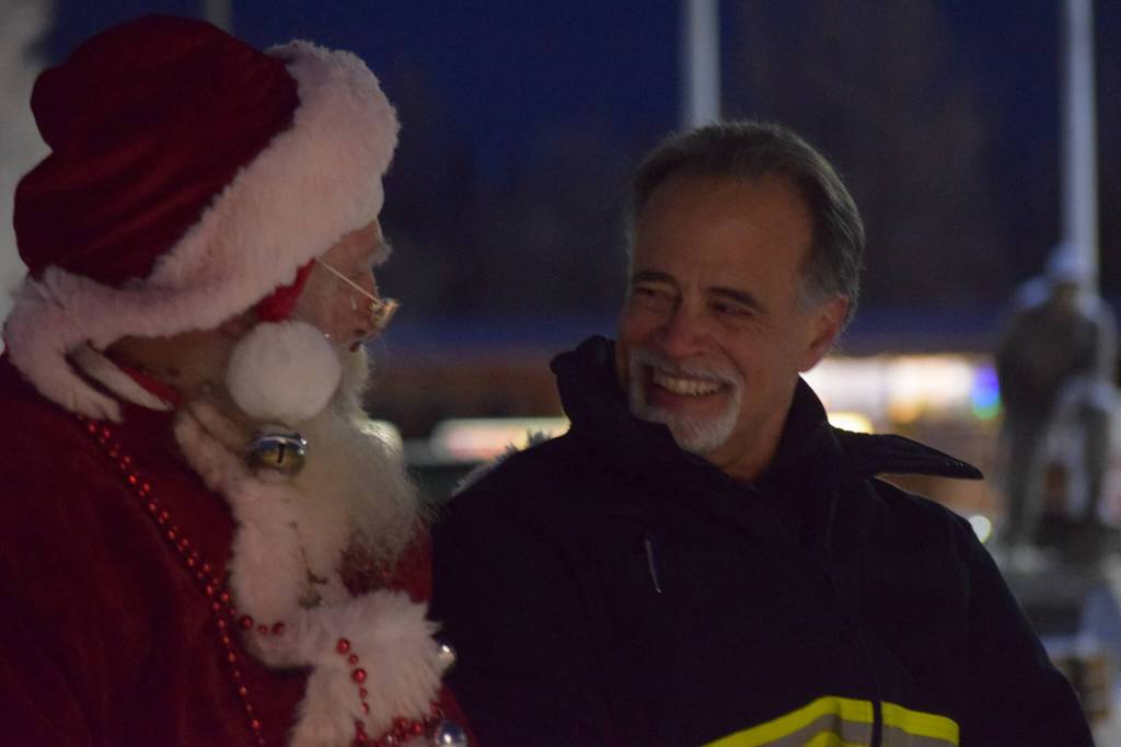 State Sen. Peter Micciche takes photos with Santa at Soldotna Creek Park on Saturday, Dec. 4, 2021. (Camille Botello/Peninsula Clarion)