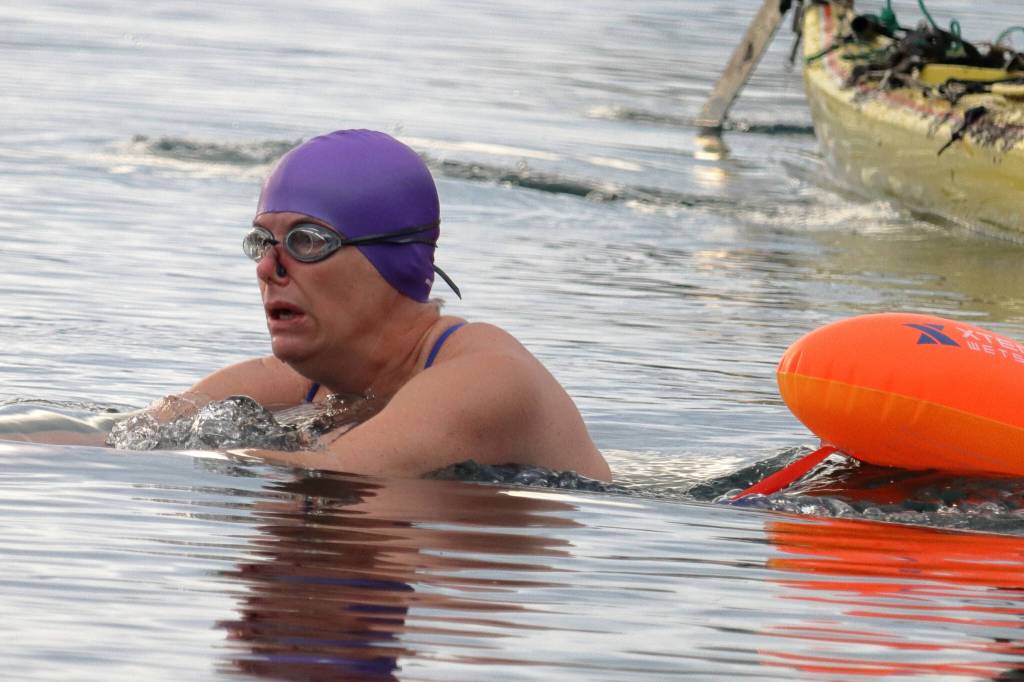 Cheryl Fellman begins her Ice Mile attempt on Saturday. The effort was witnessed by dozens and supported by a small, dedicated crew. (Ben Hohenstatt / Juneau Empire)
