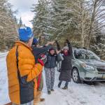 Cheryl Fellman walks through a short tunnel of supporters after spending some time warming up in a car following her Ice Mile swim.