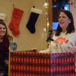 Jacquelynn Tomrdle, left, and Nicole Murphy, right, present on behalf of the Kenai Peninsula Borough School District Students in Transition program at the Kenai Peninsula Association of Realtors award ceremony at Kenai Catering on Thursday, Dec. 9, 2021. (Camille Botello/Peninsula Clarion)