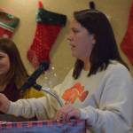 Jacquelynn Tomrdle, left, and Nicole Murphy, right, present on behalf of the Kenai Peninsula Borough School District Students in Transition program at the Kenai Peninsula Association of Realtors award ceremony at Kenai Catering on Thursday, Dec. 9, 2021. (Camille Botello/Peninsula Clarion)