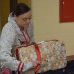 Sasha Fallon wraps gifts at the Nikiski Community Recreation Center on Saturday, Dec. 11, 2021, in Nikiski, Alaska. (Camille Botello/Peninsula Clarion)