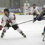 Kenai Centrals Koda Norbeck looks for a way around Soldotnas Daniel Heath and Zack Zurfluh on Tuesday, Dec. 14, 2021, at the Kenai Multi-Purpose Facility in Kenai, Alaska. (Photo by Jeff Helminiak/Peninsula Clarion)