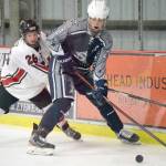 Soldotna's Dylan Dahlgren keeps the puck from Kenai Central's Toby Petty on Tuesday, Dec. 14, 2021, at the Kenai Multi-Purpose Facility in Kenai, Alaska. (Photo by Jeff Helminiak/Peninsula Clarion)
