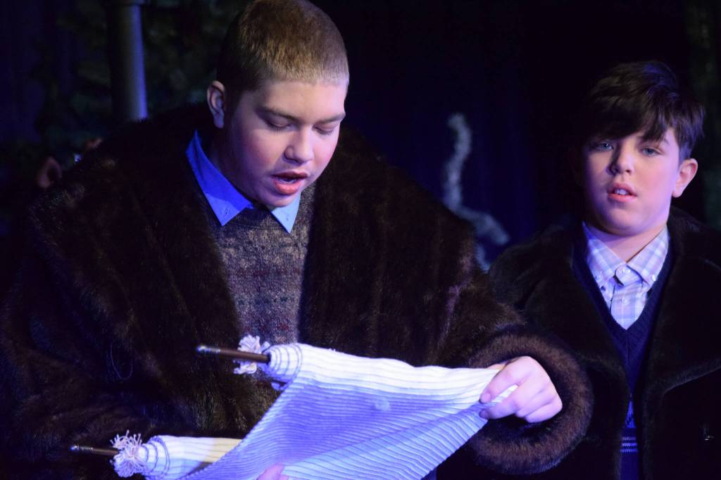 Josiah Burton and Micah Burton perform during the Triumvirate Theatres rehearsal of The Chronicles of Narnia: The Lion, the Witch and the Wardrobe at Kenai Central High School on Tuesday, Dec. 14, 2021. (Camille Botello/Peninsula Clarion)