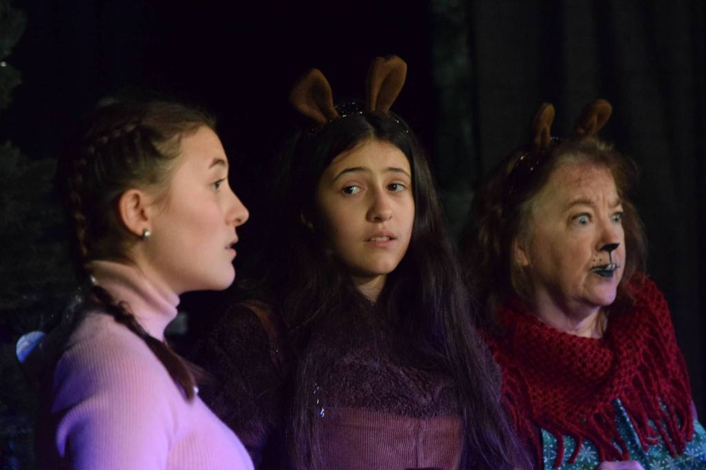 From left, Sophia Micciche, Luci Micciche and Terri Burdick perform during the Triumvirate Theatres rehearsal of The Chronicles of Narnia: The Lion, the Witch and the Wardrobe at Kenai Central High School on Tuesday, Dec. 14, 2021. (Camille Botello/Peninsula Clarion)