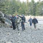 Ash Naderhoff, center, pointing, shows the rest of the team the spot where he witnessed the mysterious figure that morning and documented its scat in the woods. (Courtesy Photo by Daniel Lennon/Discovery+)
