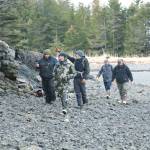 Ash Naderhoff, center, pointing, shows the rest of the team the spot where he witnessed the mysterious figure that morning and documented its scat in the woods. (Courtesy Photo by Daniel Lennon/Discovery+)