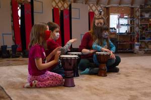 Fireweed Academy kindergarteners drum along with Sankofa Dance Theatre during their residency on Thursday, Dec. 9. (Photo by Sarah Knapp/Homer News)