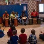 Sankofa Dance Theater Alaska teaches the Fireweed Academy Kindergarten class how to perform traditional African music during their residency on Dec. 9. (Photo by Sarah Knapp/Homer News)