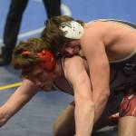 Nikiskis Simon Grenier wins a title in the Division II state wrestling championship at the Alaska Airlines Center in Anchorage on Saturday, Dec. 18, 2021. (Camille Botello/Peninsula Clarion)