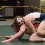 Soldotnas Liam Babitt wins a title in the Division I state wrestling championship at the Alaska Airlines Center in Anchorage on Saturday, Dec. 18, 2021. (Camille Botello/Peninsula Clarion)