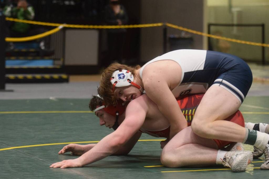 Soldotnas Liam Babitt wins a title in the Division I state wrestling championship at the Alaska Airlines Center in Anchorage on Saturday, Dec. 18, 2021. (Camille Botello/Peninsula Clarion)