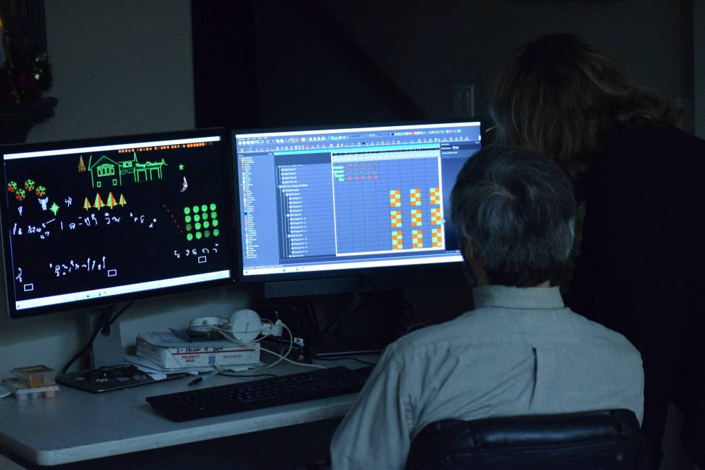 Robin and Jim Allemann program their Christmas light show from inside their home in Nikiski on Sunday, Dec. 19, 2021. (Camille Botello/Peninsula Clarion)