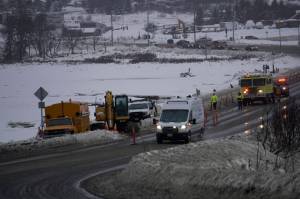 Homer Volunteer Fire Department firefighters respond to a natural gasline break on Lake Street at the Beluga Lake causeway at about 12:30 p.m. Monday, Dec. 20, 2021, in Homer, Alaska. (Photo by Michael Armstrong/Homer News)