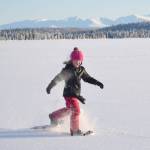 Drew Slegers, a fourth grader at Soldotna Elementary, snowshoes on Headquarters Lake just outside of Soldotna, Alaska, on Tuesday, Dec. 21, 2021. (Photo by Jeff Helminiak/Peninsula Clarion)