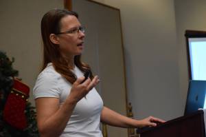 Sara Bieber, Gulf Coast manager of the Alaska Department of Labor and Workforce Development, speaks to the Central Peninsula Young Professionals at the Kenai Chamber of Commerce and Visitor Center on Tuesday, Dec. 21, 2021. (Camille Botello/Peninsula Clarion)