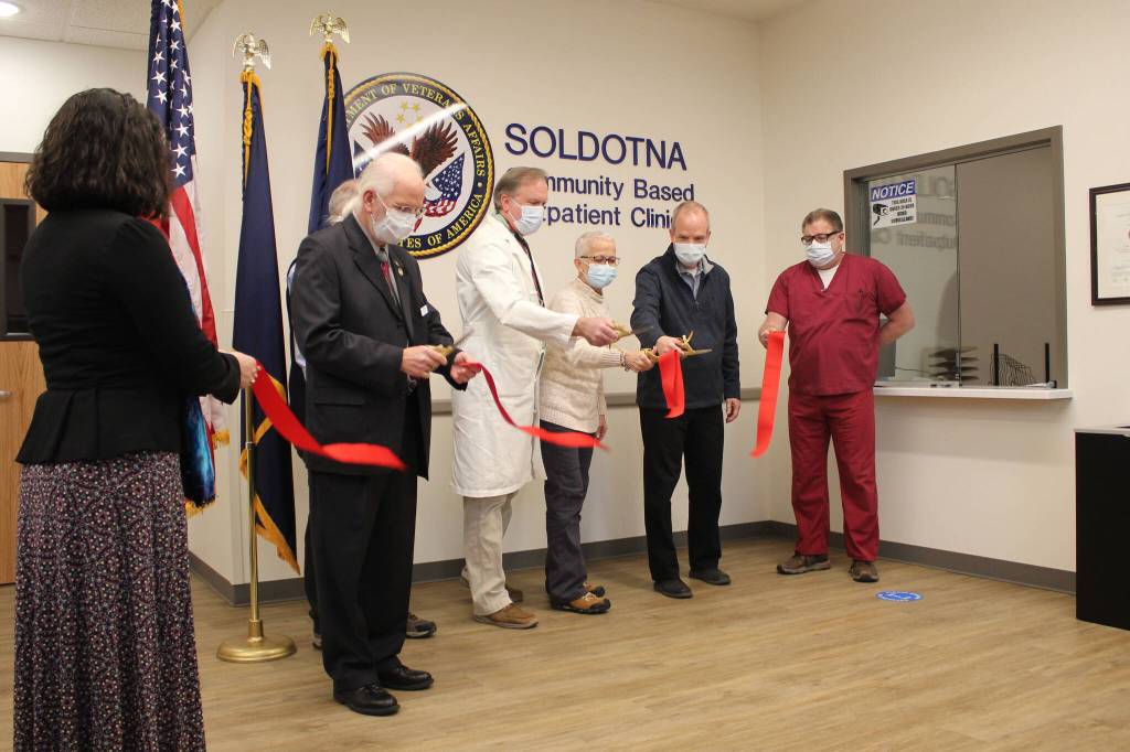 Stakeholders cut a ribbon at the Soldotna Community Based Outpatient Clinic on Thursday, Dec. 29, 2021 in Soldotna, Alaska. (Ashlyn OHara/Peninsula Clarion)