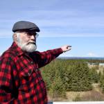 Pete Kineen, a neighbor of the proposed Beachcomber LLC gravel pit, stands on his deck and points to where the pit could be, on May 2, 2019, in Anchor Point, Alaska. (Photo by Victoria Petersen/Peninsula Clarion)