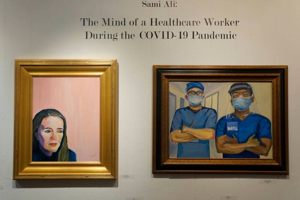 Two paintings in in Dr. Sami Alis exhibit, The Mind of a Healthcare Worker During the COVID-19 Pandemic, showing in January 2022 at the Homer Council on the Arts in Homer, Alaska. (Photo by Michael Armstrong/Homer News)