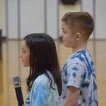 Avi Bloom and Hudson Morris speak about their National Blue Ribbon award during an assembly at Soldotna Montessori Charter School on Friday, Jan 14, 2022. (Camille Botello / Peninsula Clarion)