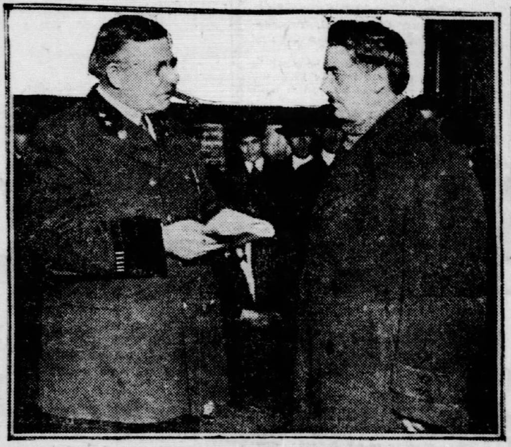 Dr. Rudolph Gries (right) is confronted by Despaines (Illinois) Police Capt. Max Danner after his arrest in January 1921. (Photo from the Chicago Tribune)