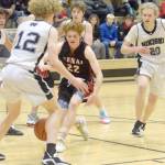 Kenai Centrals Wade James loses the ball in front of Nikiskis Brady Bostic on Friday, Jan. 14, 2022, at Nikiski High School in Nikiski, Alaska. (Photo by Jeff Helminiak/Peninsula Clarion)